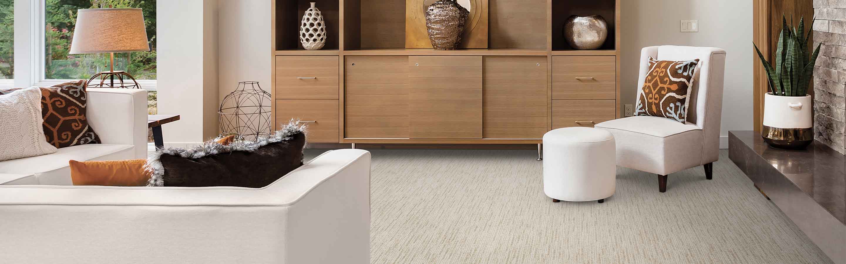 Living room with custom wood built-in entertainment center, white furniture and beige patterned carpet